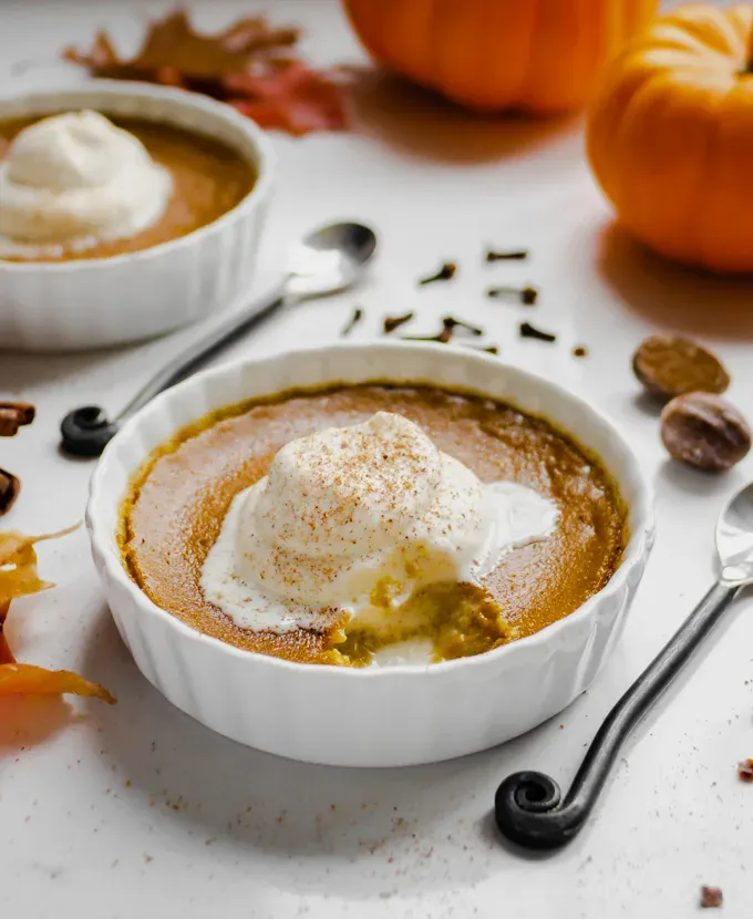 This baked pumpkin custard is a gluten free way to enjoy some wonderful fall spices. It’s basically like individual crustless pumpkin pies!' title='Easy Baked Pumpkin Custard with Nutmeg Whipped Cream