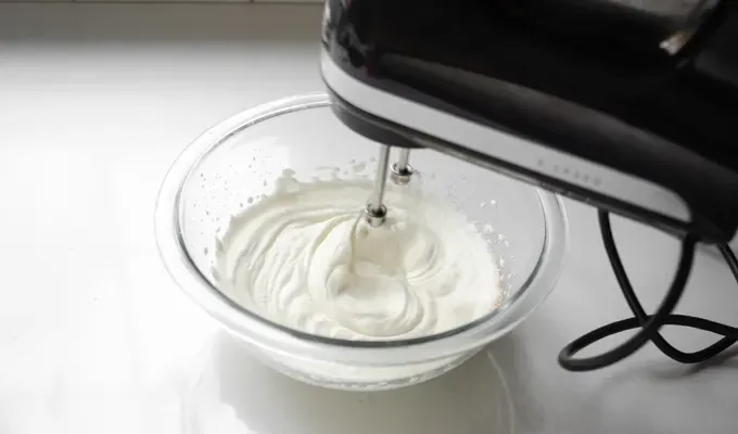 Whipping the nutmeg whipped cream until soft peaks form.' title='Easy Baked Pumpkin Custard with Nutmeg Whipped Cream