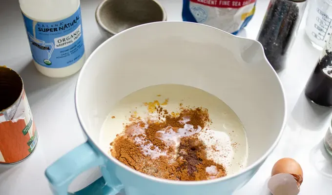 All of the ingredients in a large bowl.' title='Easy Baked Pumpkin Custard with Nutmeg Whipped Cream