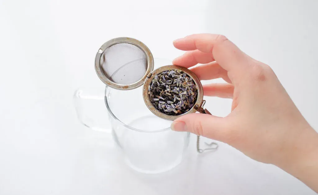 Adding the earl grey tea and lavender to a tea strainer. ' title='Homemade London Fog Tea Latte (Earl Grey Latte)