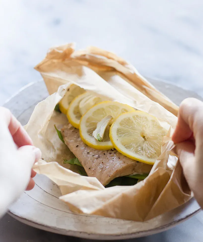 Opening up a Salmon en Papillote.' title='Salmon en Papillote