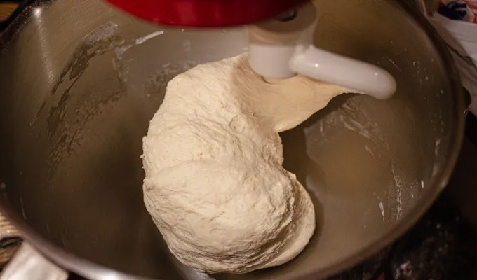 The dough in a stand mixer fitted with a dough attachment. ' title='Soft Sourdough French Bread Without Yeast!