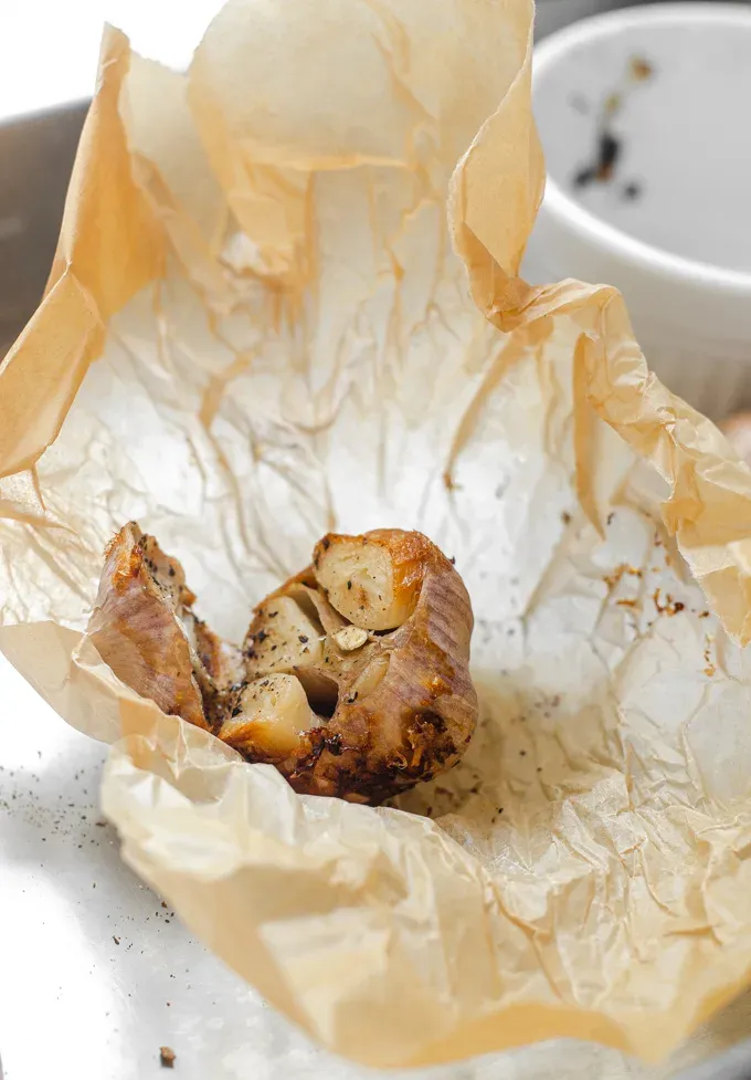 How to roast garlic without foil using parchment paper instead.' title='How to Roast Garlic Without Aluminum Foil
