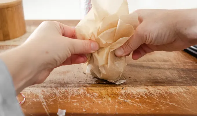 Gathering the sides of the parchment paper up.' title='How to Roast Garlic Without Aluminum Foil