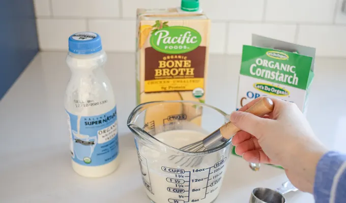 Whisking together the cream chicken broth and cornstarch.' title='Gluten Free Cheesy Potatoes