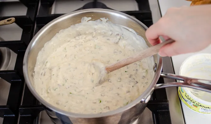 Stirring the soup base and French onion dip together.' title='Gluten Free Cheesy Potatoes