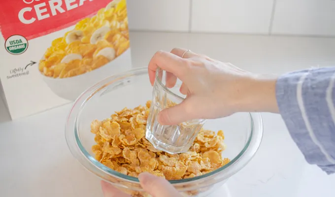 Crushing the cornflakes to put on top of the gluten free cheesy potatoes (AKA funeral potatoes).' title='Gluten Free Cheesy Potatoes