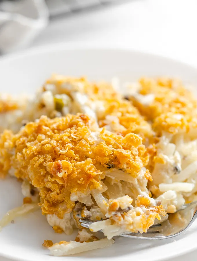 A close up shot of a plate of gluten free cheesy potatoes (AKA funeral potatoes).' title='Gluten Free Cheesy Potatoes
