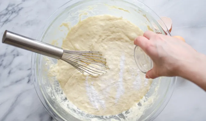 Sprinkling the baking soda on top of the batter.' title='The Best Sourdough Pancakes