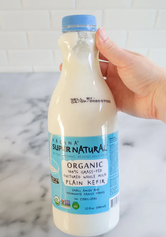 Holding a bottle of Kalona SuperNatural kefir.' title='The Best Sourdough Pancakes