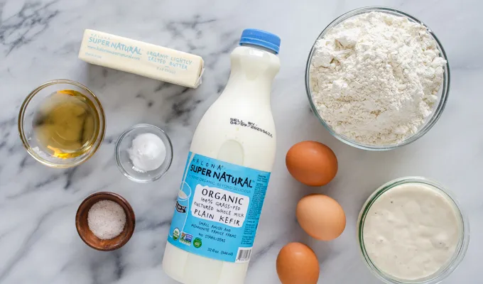 All of the ingredients for sourdough pancakes laid out on a marble surface.' title='The Best Sourdough Pancakes