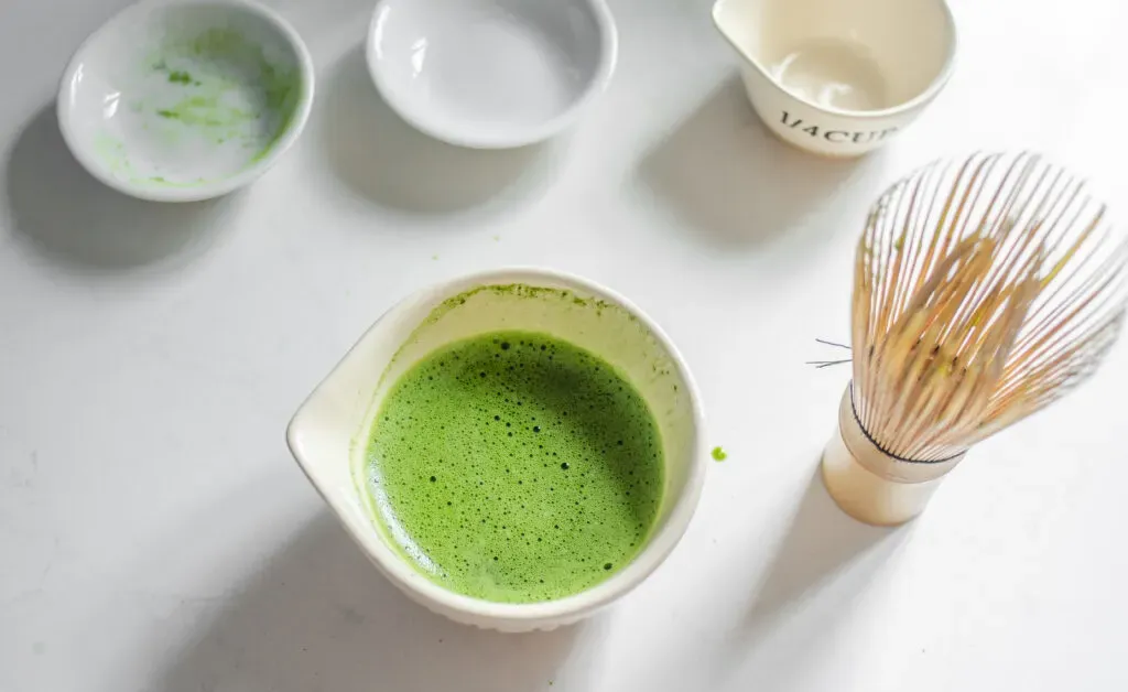 A bowl of whisked matcha sugar and water ready to be make into a Starbucks hot matcha green tea latte.' title='Starbucks Hot Matcha Green Tea Latte Recipe