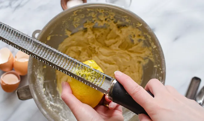 Adding lemon zest to the batter.' title='Sour Cream Pound Cake Loaf