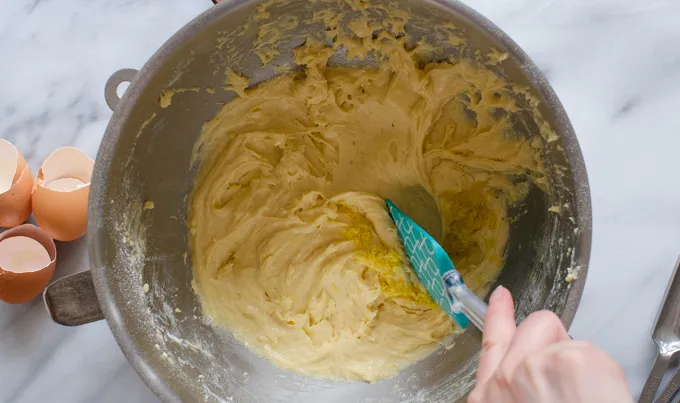 Folding the lemon zest into the sour cream pound cake loaf batter.' title='Sour Cream Pound Cake Loaf