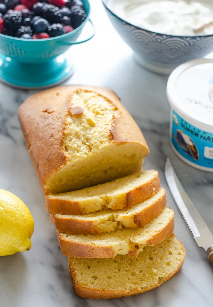 Slices of sour cream pound cake loaf on a marble surface.' title='Sour Cream Pound Cake Loaf