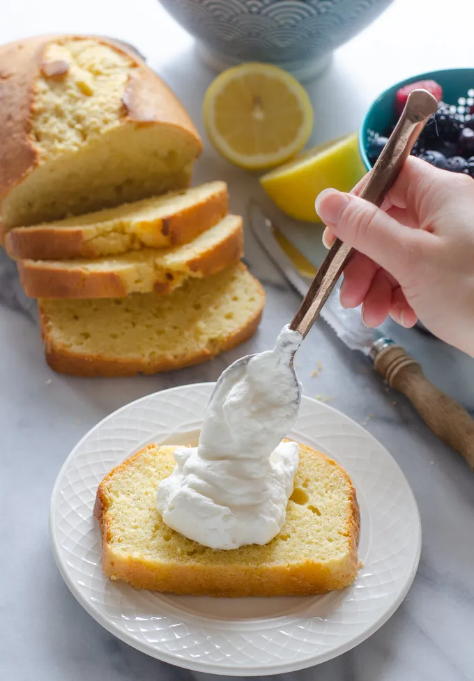 Topping the slice with whipped cream.' title='Sour Cream Pound Cake Loaf