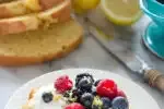 A slice of sour cream pound cake loaf topped with whipped cream and berries.' title='Sour Cream Pound Cake Loaf