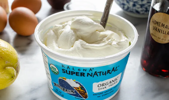 An open tub of Kalona SuperNatural sour cream.' title='Sour Cream Pound Cake Loaf