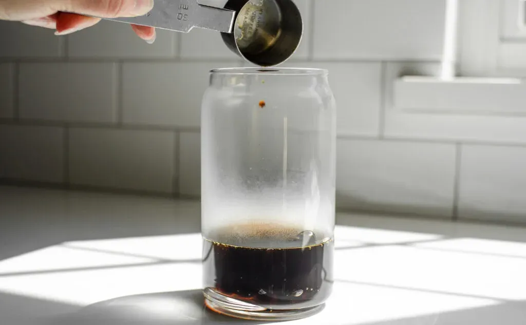 Adding the brown sugar simple syrup on top of the boba.' title='How to Make Matcha Milk Tea with Boba