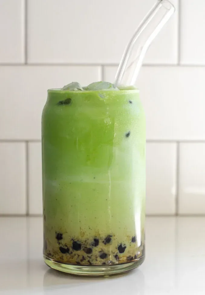 A glass of matcha milk tea with tapioca pearls (Boba).' title='How to Make Matcha Milk Tea with Boba