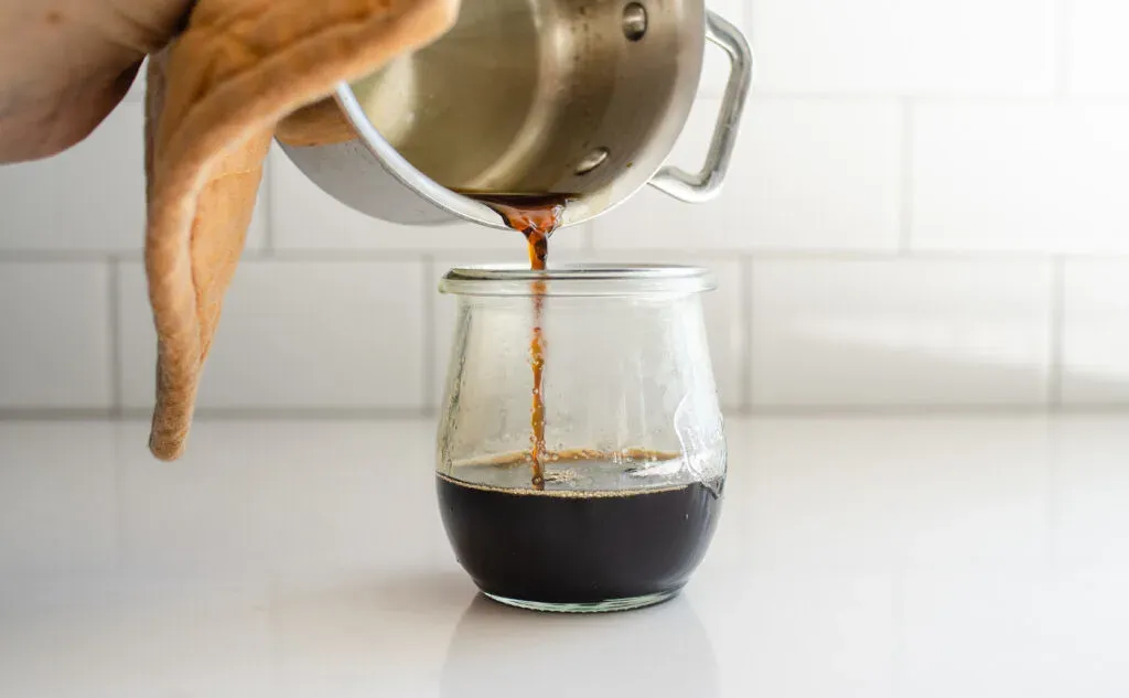 Pouring the finished brown sugar simple syrup into an airtight container. ' title='How to Make Matcha Milk Tea with Boba