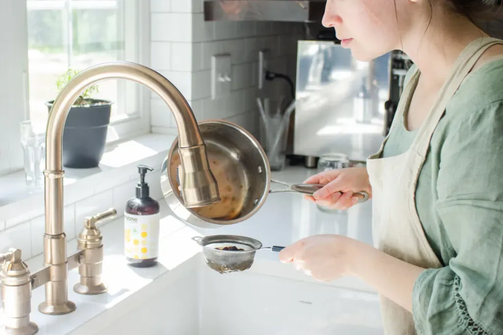 Straining the cooked boba into the sink.' title='How to Make Matcha Milk Tea with Boba
