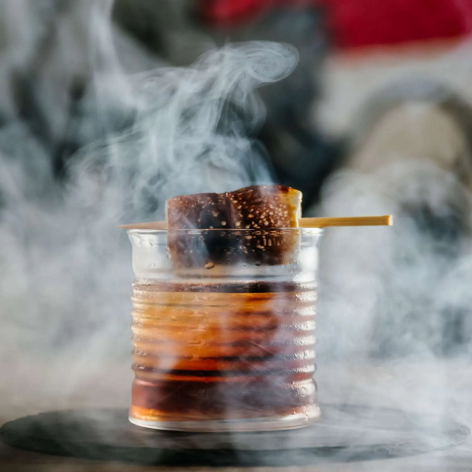 Old Fashioned in rocks glass with toasted marshmallows and heavy smoke