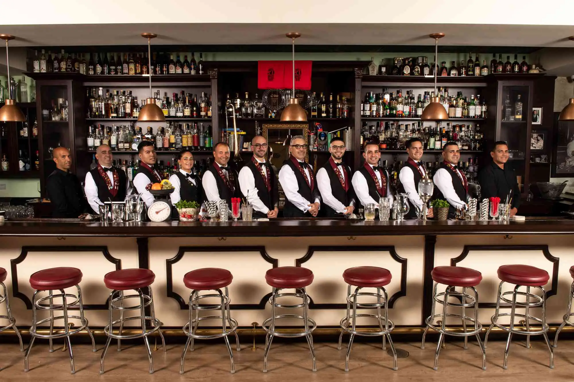 Interior of Cafe la Trova, with bartenders standing in a row behind bar