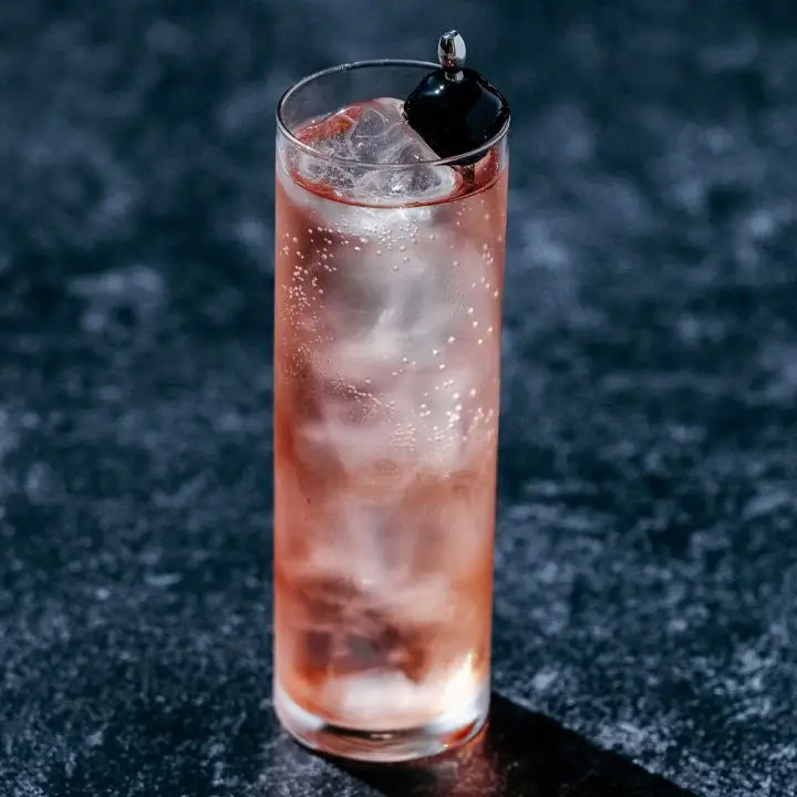 The Dirty Shirley cocktail in collins glass on dark countertop