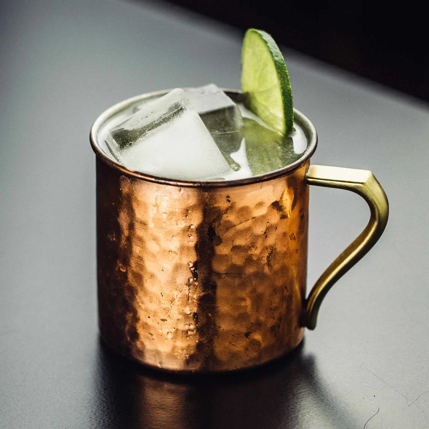 Moscow mule in copper cup with lime wheel