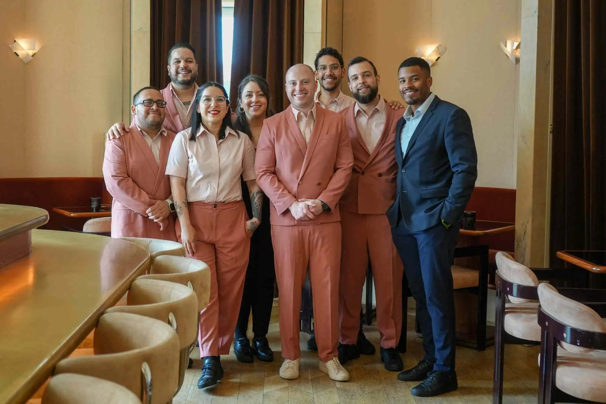 Harrison Ginsberg and the staff atOverstory standing next to the bar