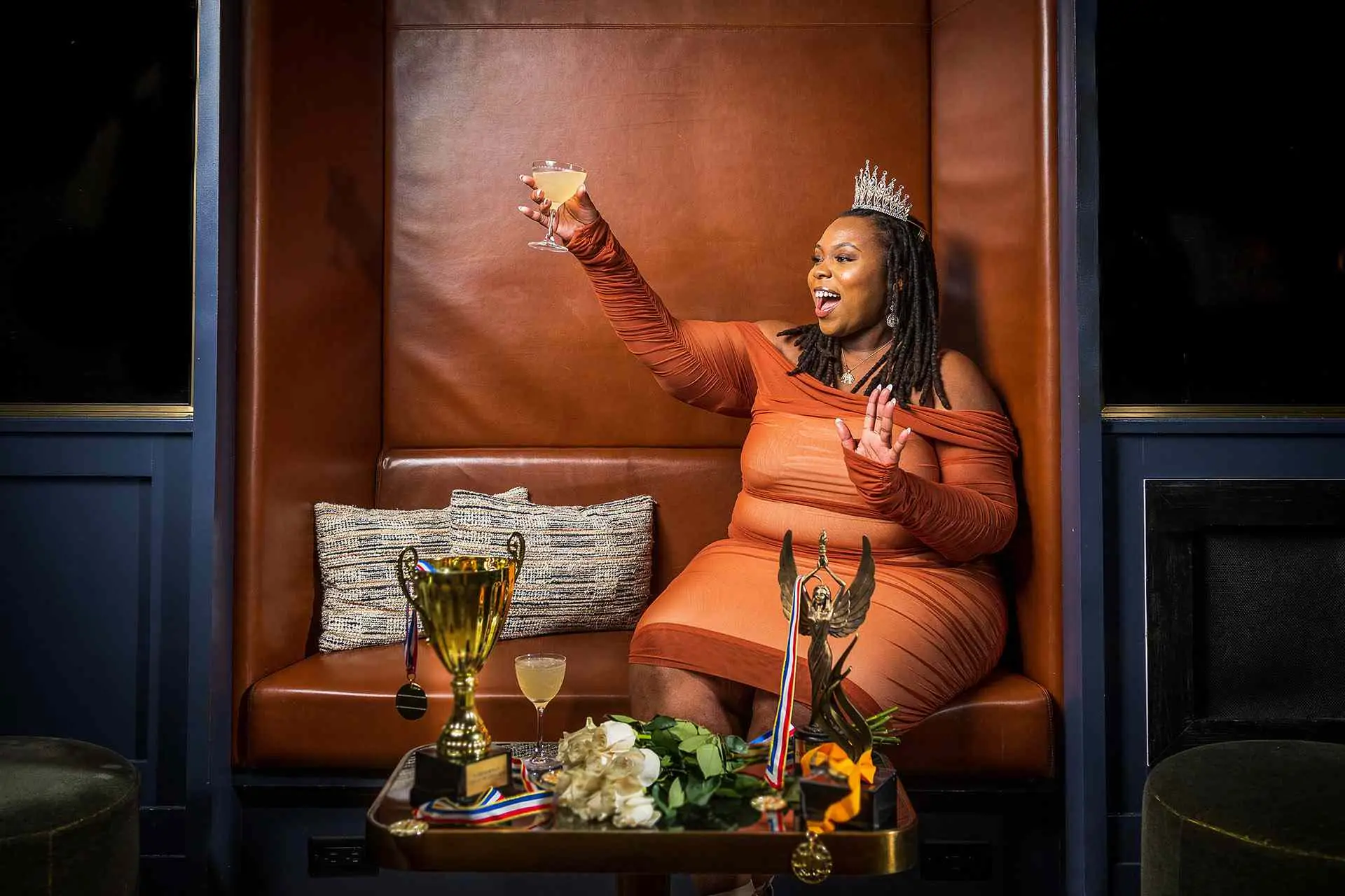 Kapri Robinson toasting with a crown