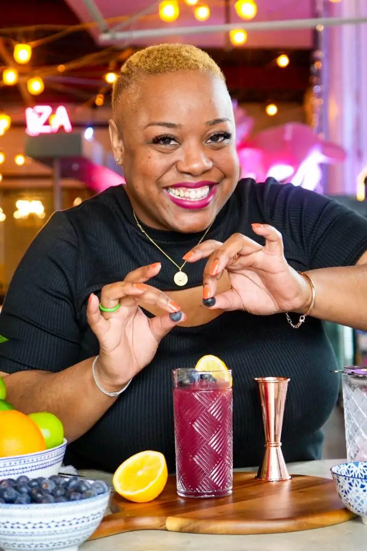 Tiffanie Barriere garnishing a cocktail