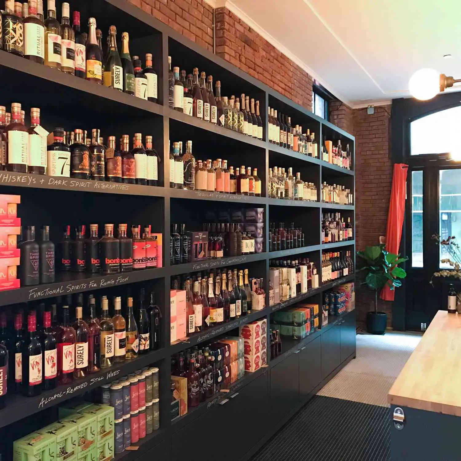 Shelves lining brick wall interior photo of Spirited Away non-alcoholic bottle shop