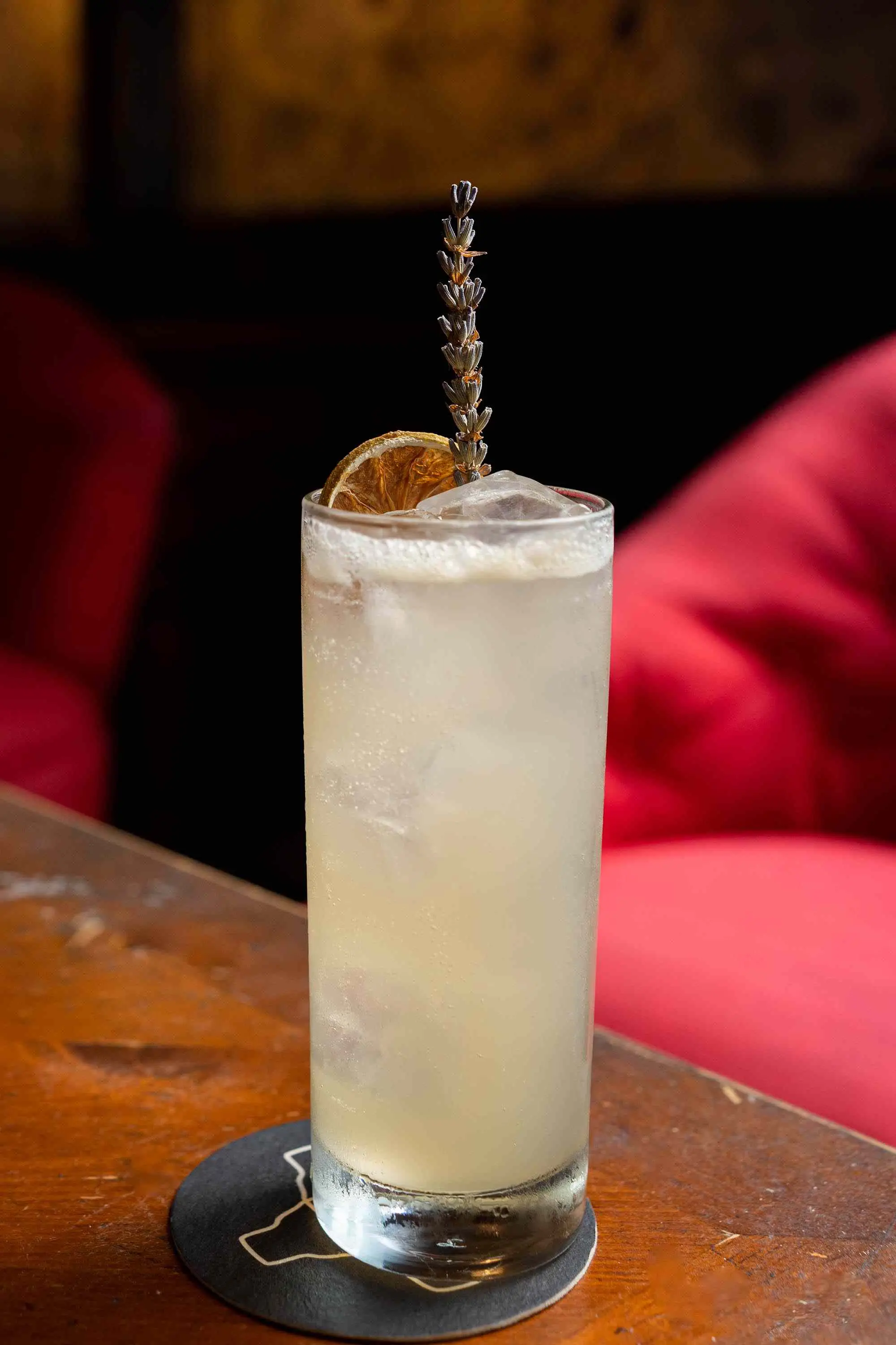 Lavender Mule in Collins glass with lavender sprig and dehydrated orange peel on bar