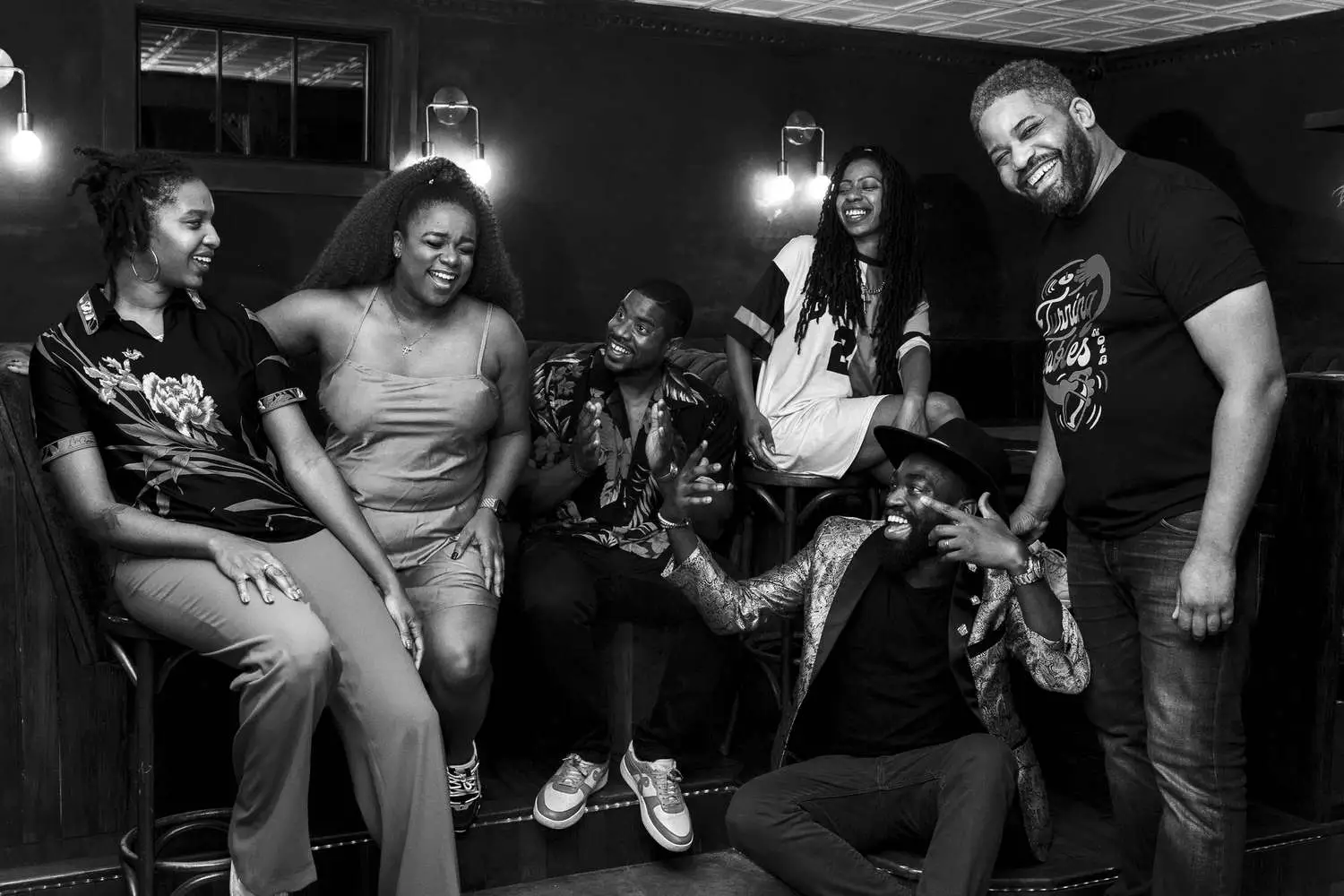 Black and white photo of Turning Tables group smiling and laughing