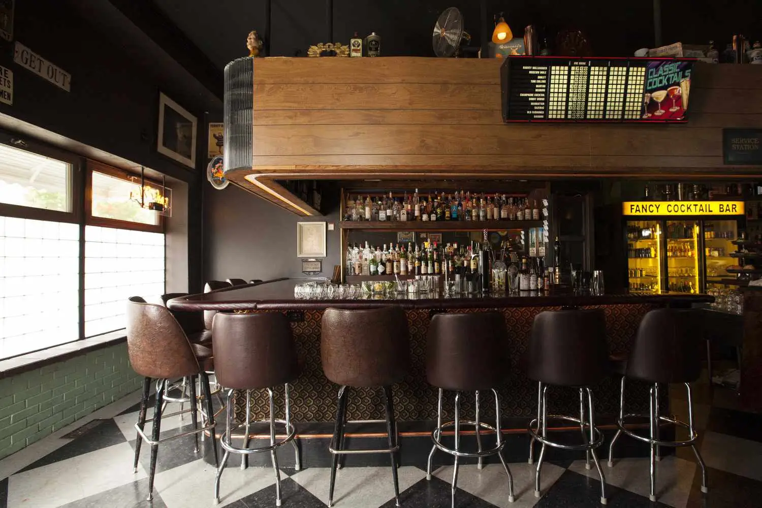 Interior of Best Intentions showing bar stools, menu hanging, and back bar