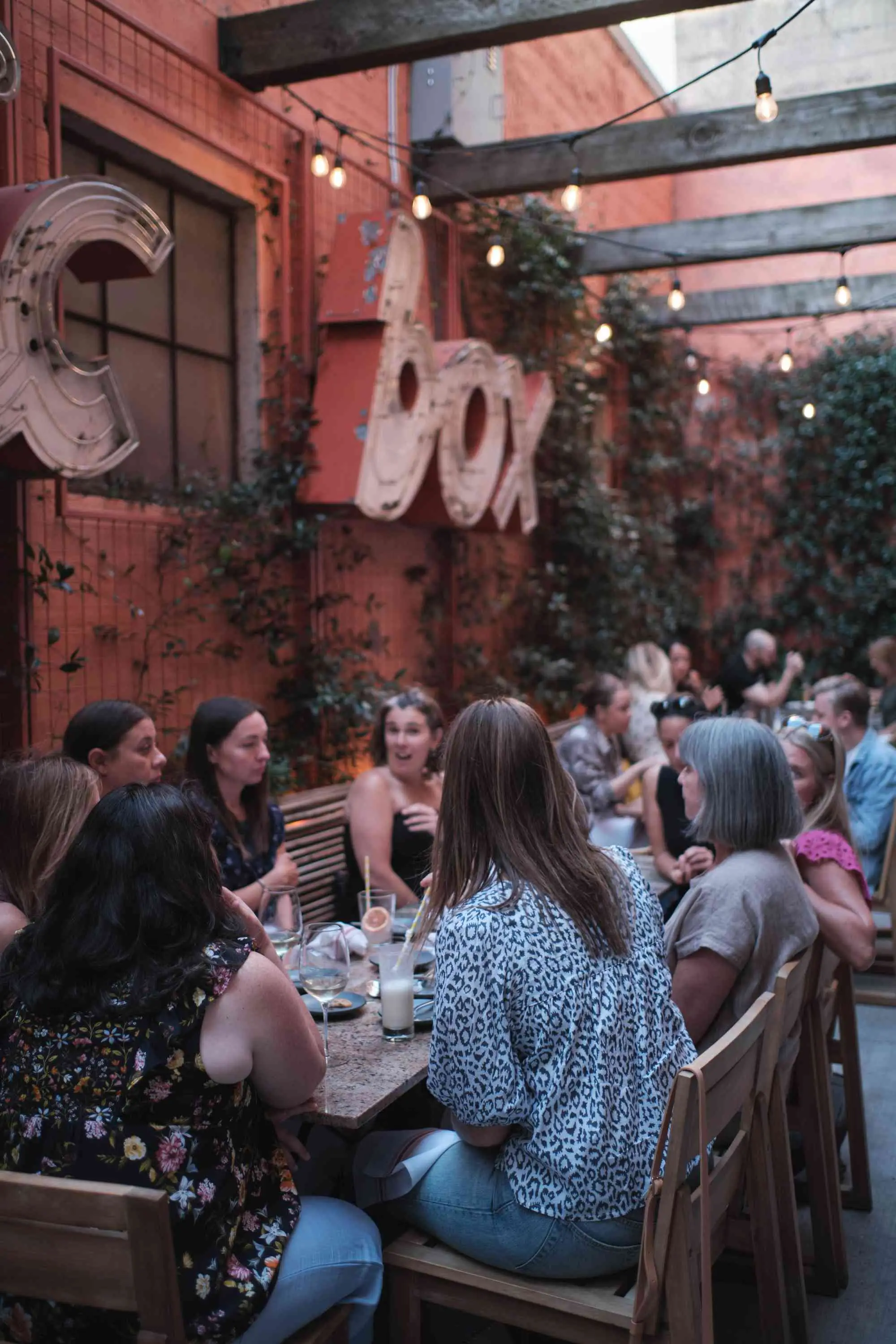Outdoor seating at Pacific Standard in Portland Oregon with exposed beams and twinkle lights