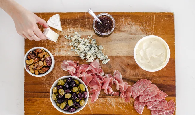 Adding the meat and cheese.' title='Easy Snack Board Ideas