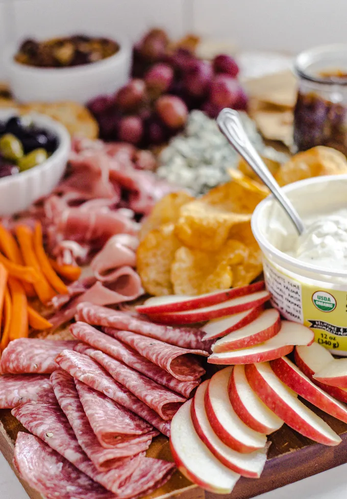 Various snacks on a wooden cutting board.' title='Easy Snack Board Ideas