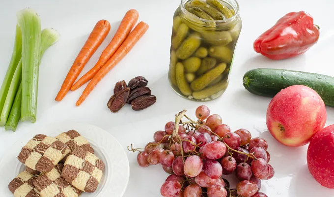 Fresh fruits and veggies pickles and cookies laid out on a counter. ' title='Easy Snack Board Ideas