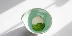 Matcha powder and cane sugar in a spouted bowl.' title='Matcha Coffee Recipe