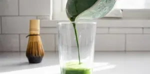 Pouring the matcha mixture into a 12 ounce glass.' title='Matcha Coffee Recipe
