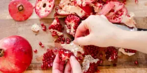 Removing the membrane from the pomegranate sections.' title='How to Remove Seeds from a Pomegranate