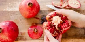 Breaking the pomegranate into sections.' title='How to Remove Seeds from a Pomegranate
