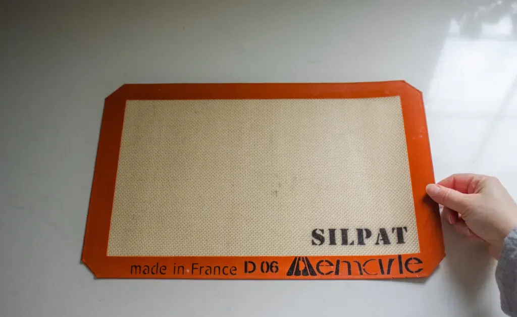 A silpat pad on a white countertop.' title='Parchment Paper Substitute for Baking