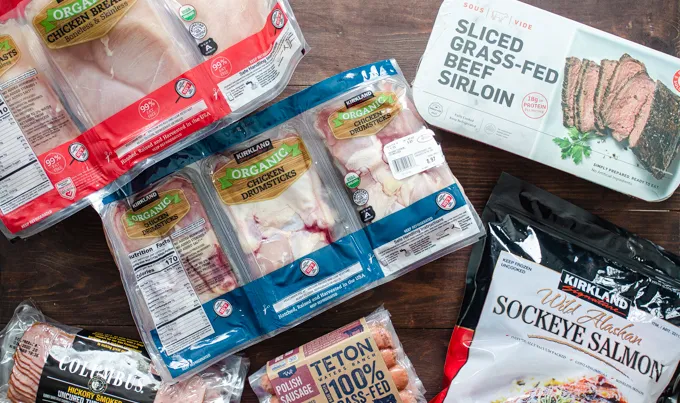 Meat that we bought at Costco laid out on a wooden surface.' title='Things to Buy at Costco: Natural and Organic Finds!