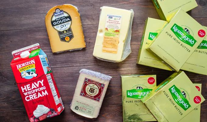 All of the dairy products we bought at Costco laid out on a wooden surface.' title='Things to Buy at Costco: Natural and Organic Finds!