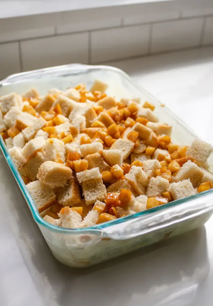 The bread and apples in a glass 13x9-inch pan.' title='Apple French Toast Casserole Recipe
