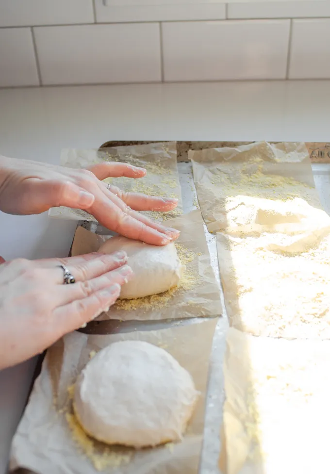 Flattening out the balls of dough.' title='Sourdough English Muffins